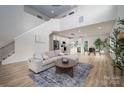Open-concept living space with modern furnishings, staircase, and view of the kitchen at 207 9Th Ne Ct, Conover, NC 28613