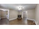 Spacious living room features a decorative fireplace, fan, and hardwood floors at 2377 Mintew Cir, Lincolnton, NC 28092