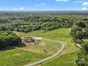 Expansive aerial view of a secluded home nestled in lush greenery with long private drive at 2521 Neely Store Rd, Rock Hill, SC 29730