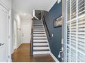 Inviting entryway featuring hardwood floors and a staircase with wooden railings at 310 N Dotger N Ave # 4, Charlotte, NC 28204