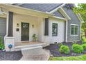 Inviting front porch with white brick columns, dark accents, and manicured landscaping around the home at 3163 Maury St, Charlotte, NC 28208