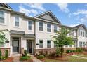 A well maintained townhome with stone accents, vinyl siding, manicured lawn and mature tree at 4117 Galloway Park Dr, Charlotte, NC 28262