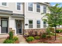 Charming front entry featuring stone accents, craftsman door with decorative wreath, and manicured landscape at 4117 Galloway Park Dr, Charlotte, NC 28262