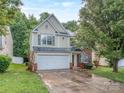 Traditional two-story home featuring green shutters and a two-car garage at 4208 Everest Dr, Gastonia, NC 28054