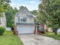 Charming two-story home with light siding, an attached garage and an extended driveway at 4208 Everest Dr, Gastonia, NC 28054