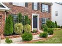 Inviting front entry with lush landscaping and a well-maintained brick facade at 4658 Cedar Rock Dr, Charlotte, NC 28273
