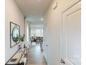 Inviting hallway featuring hardwood floors that lead to a bright and open living space at 5058 Beargrass Dr, Dallas, NC 28034