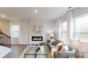 Bright living room with a modern fireplace, neutral tones, and lots of natural light at 5058 Beargrass Dr, Dallas, NC 28034