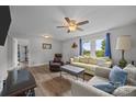 Inviting living room boasts wood-look floors, natural light, and comfortable seating arrangement at 5371 Davidson Rd, Davidson, NC 28036