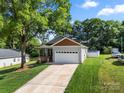 Charming single-Gathering home with a well-maintained lawn and an attached two-car garage at 6578 Bopre Ln, Denver, NC 28037