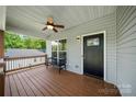 Cozy front porch with a ceiling fan, bench seating, and view of the front yard at 6578 Bopre Ln, Denver, NC 28037