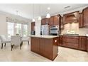 Modern kitchen with a central island, stainless steel appliances, and dark wood cabinetry at 7036 Kitty Hawk Ln, Fort Mill, SC 29707