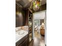 Butler's pantry with wine storage, marble countertop, and dark wood cabinets at 7428 Edenbridge Ln, Charlotte, NC 28226
