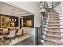 Elegant dining room with hardwood floors, grand staircase, chandelier, and decorative wall paneling at 7428 Edenbridge Ln, Charlotte, NC 28226