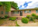 Beautiful brick home featuring a landscaped front yard, welcoming porch, and charming exterior details at 8282 Park Edwards Rd, Kannapolis, NC 28081