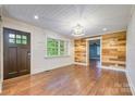 Inviting living room with hardwood floors, shiplap walls, and a large window, offering natural light at 8282 Park Edwards Rd, Kannapolis, NC 28081