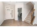 Bright foyer with hardwood floors, a staircase with wooden banister, and a view into the office at 829 River Park Rd, Belmont, NC 28012