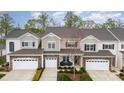 Charming townhome with stone accents, attached garage, and cozy front porch with chairs at 829 River Park Rd, Belmont, NC 28012