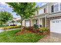Beautiful townhome exterior with stone accents and colorful landscaping creating a welcoming curb appeal at 829 River Park Rd, Belmont, NC 28012