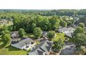 Residential neighborhood with mature trees, single-Gathering homes, and well-maintained green lawns at 112 Dujon Ct, Mount Holly, NC 28120