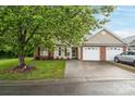 Single-story home with attached garage, mature tree, and manicured lawn at 112 Dujon Ct, Mount Holly, NC 28120