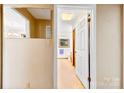 View into bathroom with mirror, wallpaper, and natural light from window at 113 Helena St, Mount Holly, NC 28120