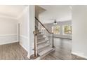 Inviting home entryway with hardwood floors, carpeted stairs, and a view to the living room at 11526 Mcginns Trace Ct, Charlotte, NC 28277