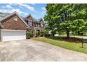 Charming brick home with attached garage, mature landscaping, and a spacious driveway at 11526 Mcginns Trace Ct, Charlotte, NC 28277