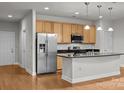 Bright, open kitchen with stainless steel appliances, island, and sleek countertops at 120F Steinbeck Way, Mooresville, NC 28117