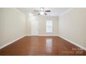 Inviting living room featuring hardwood floors, ample natural light, and a front entry door at 13358 Calloway Glen Dr, Charlotte, NC 28273