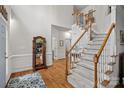 Elegant entryway featuring hardwood floors, a staircase with carpet, and decorative mirror at 1402 Coachman Dr, Waxhaw, NC 28173