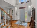 Grand foyer with soaring ceilings, hardwood floors, and a stylish blue patterned rug at 1402 Coachman Dr, Waxhaw, NC 28173