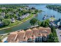 Stunning aerial view showcases waterfront condos and lush landscaping at 18631 Harborside Dr, Cornelius, NC 28031