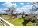 Backyard view of waterfront homes with lush green grass at 18631 Harborside Dr, Cornelius, NC 28031