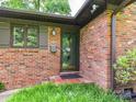 Close-up of the brick home's entrance, showcasing the front door and surrounding architectural details at 2401 Wensley Dr, Charlotte, NC 28210