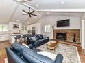 Open-concept living room with vaulted ceilings, fireplace, and seamless flow into the modern kitchen at 2401 Wensley Dr, Charlotte, NC 28210