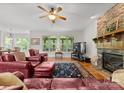 Cozy living room with stone fireplace, plush seating, hardwood floors, and plenty of natural light at 2606 Walker Rd, Matthews, NC 28105