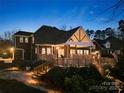 Exterior view of back of brick home with a spacious wooden deck at 3115 Duck Point Dr, Monroe, NC 28110