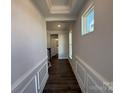 Bright hallway with detailed trim, dark wood floors, and a view into the bathroom at 4131 Black Ct # 170, Harrisburg, NC 28075