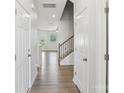 Bright hallway with hardwood floors and staircase leading to upper level at 5254 Spanish Ivy Ln # 133, Indian Land, SC 29707
