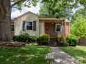 Charming single-story home with brick accents, a welcoming porch, and a well-manicured front yard at 557 Melbourne Ct, Charlotte, NC 28209