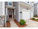 Close-up of the front entrance featuring a garage, walkway, and manicured landscaping at 5625 Axil Ln, Charlotte, NC 28269