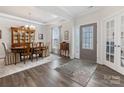 Elegant dining room featuring hardwood floors, a decorative hutch, and stylish furnishings at 603 Southstone Dr, Matthews, NC 28104