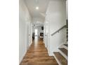 Inviting hallway with wood floors, leading to dining area and featuring a staircase at 6037 Chelsea Oaks Rdg # 77, Tega Cay, SC 29708