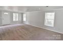 Bright living room with large windows and neutral carpet provides a welcoming atmosphere at 6124 Old Mt Holly Rd, Charlotte, NC 28208