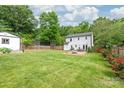 Spacious backyard featuring a large lawn, a patio area, and a fenced perimeter at 618 Heathermoor Ct, Charlotte, NC 28209