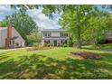 Lovely home with lush green lawn, mature trees, and beautiful landscaping at 618 Heathermoor Ct, Charlotte, NC 28209