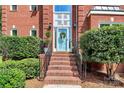 Inviting front entrance with a wreath, brick steps, and manicured shrubbery at 655 Powder Horn Ln, Indian Trail, NC 28079