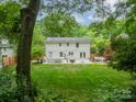 Spacious backyard with lush greenery, patio area, and outdoor seating at 6621 Ronda Ave, Charlotte, NC 28211