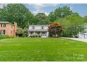 Beautifully landscaped front yard enhances this two-story home's curb appeal at 6621 Ronda Ave, Charlotte, NC 28211
